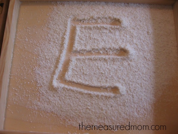 letter E written in cornmeal