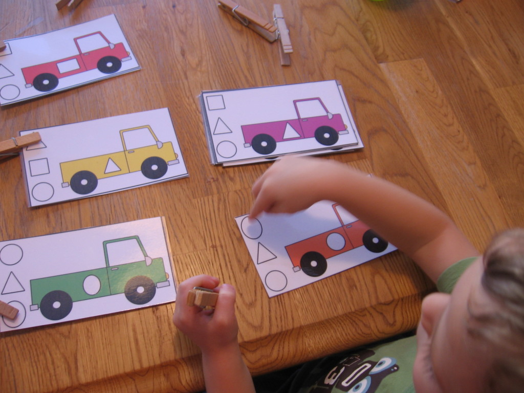 child with truck loading shape clip cards letter T