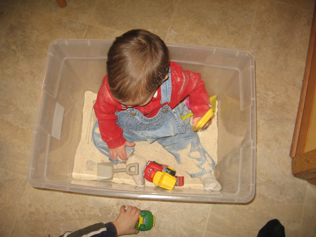 baby playing in "sandbox"
