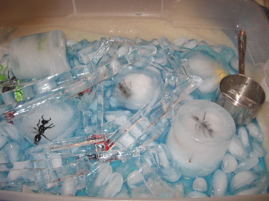 toy insects in ice with icicles and blue water