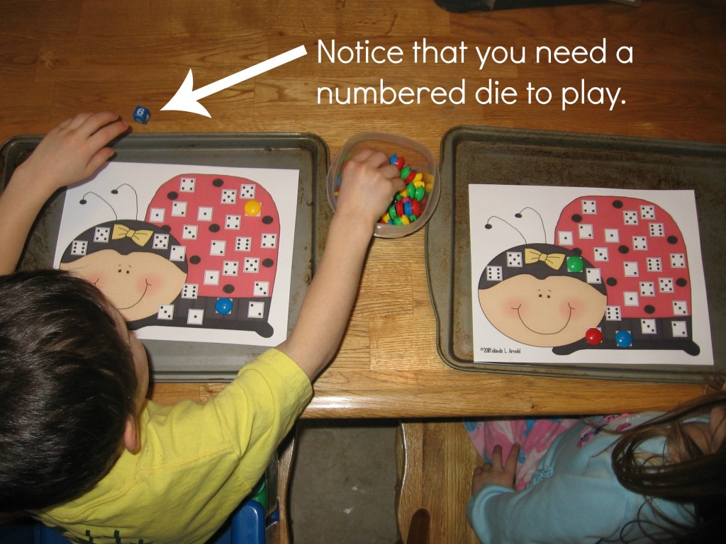 children playing ladybug roll and cover math game