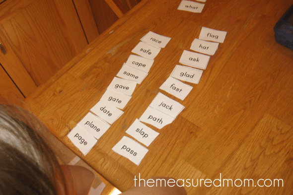 child sorting word cards