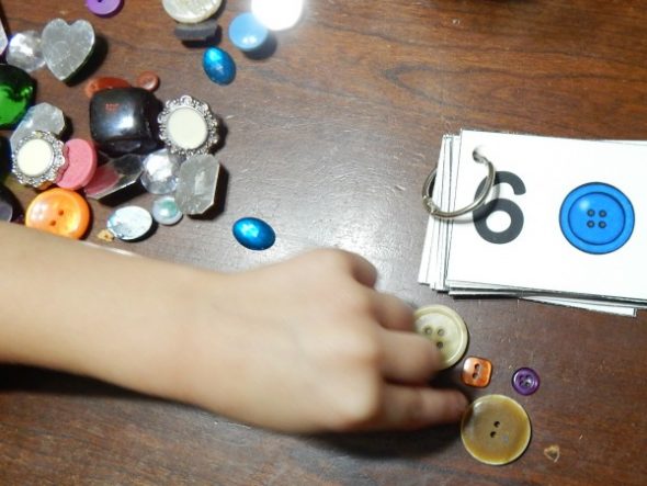 child counting buttons